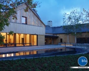 Large reflecting pool spanning almost the width of the building and includes lighting to differentiate the walkway and water.