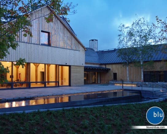 Large reflecting pool spanning almost the width of the building and includes lighting to differentiate the walkway and water.